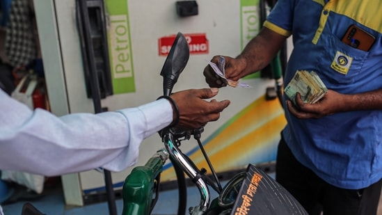 A motorcyclist pays while refueling at a Bharat Petroleum Corp. gas station in Jalgaon, Maharashtra, India, on Monday, July 19, 2021. (Bloomberg) A motorcyclist pays while refueling at a Bharat Petroleum Corp. gas station in Jalgaon, Maharashtra, India, on Monday, July 19, 2021. (Bloomberg)