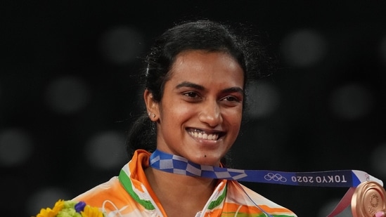 Tokyo: India's Pusarla V. Sindhu poses for photographs while standing on the podium after receiving the bronze medal in women's singles badminton event at the Summer Olympics 2020, in Tokyo, Sunday, August 1, 2021. (PTI Photo/Gurinder Osan)(PTI08_01_2021_000252B)(PTI)