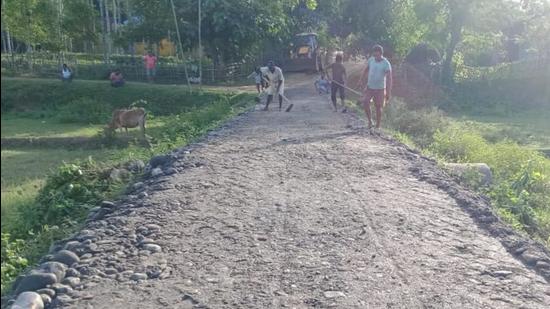 Workers busy repairing the road to Lovlina Borgohain’s house at Baromukhia village in Assam. (HT Photo) Workers busy repairing the road to Lovlina Borgohain’s house at Baromukhia village in Assam. (HT Photo)