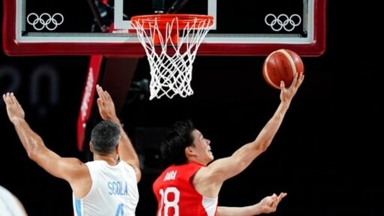 Japan's Yudai Baba (18), right, drives to the basket past Argentina's Luis Scola (4) during men's basketball preliminary round game at the 2020 Summer Olympics, Sunday, Aug. 1, 2021, in Saitama, Japan. (AP Photo/Charlie Neibergall)(AP)