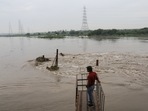 A view of Yamuna river flowing over the danger mark at Iron Bridge in New Delhi, India, on Sunday, August 1, 2021. (Photo by Sanchit Khanna/ Hindustan Times)