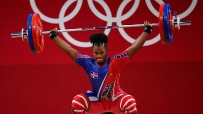 Crismery Dominga Santana Peguero of Dominican Republic competes in the women's 87kg weightlifting event at the 2020 Summer Olympics, Monday, Aug. 2, 2021, in Tokyo, Japan. (AP Photo/Luca Bruno) (AP) Crismery Dominga Santana Peguero of Dominican Republic competes in the women's 87kg weightlifting event at the 2020 Summer Olympics, Monday, Aug. 2, 2021, in Tokyo, Japan. (AP Photo/Luca Bruno) (AP)