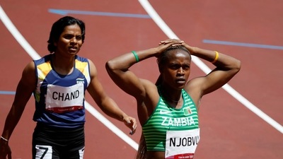 Tokyo 2020 Olympics - Athletics - Women's 200m - Round 1 - Olympic Stadium, Tokyo, Japan - August 2, 2021. Dutee Chand of India and Rhoda Njobvu of Zambia react after competing in Heat 4 REUTERS/Phil Noble (REUTERS)