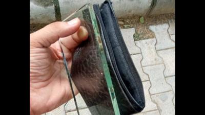 The complainant displays the glass slab he found inside the package sold by an unidentified man in Sector 52. The complainant displays the glass slab he found inside the package sold by an unidentified man in Sector 52.