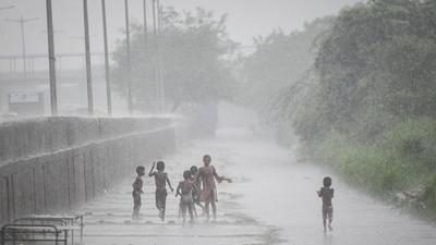 Children play in the rain at Shastri Park in New Delhi. (Sanchit Khanna/HT PHOTO) Children play in the rain at Shastri Park in New Delhi. (Sanchit Khanna/HT PHOTO)