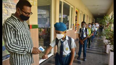 Students undergoing a thermal screening at a school in Amritsar on Monday. (Sameer Sehgal/ht)