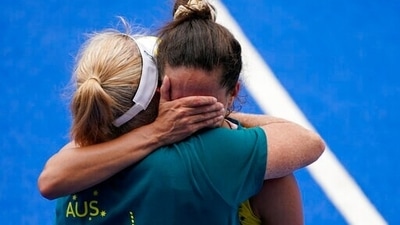 Australia's Brooke Peris is consoled by a member of the team staff after losing their women's field hockey match against India at the 2020 Summer Olympics, Monday, Aug. 2, 2021, in Tokyo, Japan. (AP Photo/John Locher) (AP) Australia's Brooke Peris is consoled by a member of the team staff after losing their women's field hockey match against India at the 2020 Summer Olympics, Monday, Aug. 2, 2021, in Tokyo, Japan. (AP Photo/John Locher) (AP)