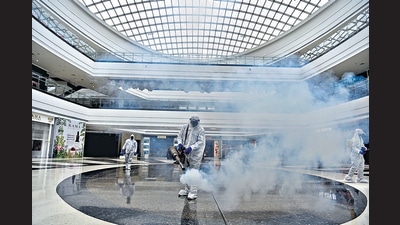 Workers seen sanitising the premises of Seawoods Grand Central Mall. (Bachchan KumarHT) Workers seen sanitising the premises of Seawoods Grand Central Mall. (Bachchan KumarHT)