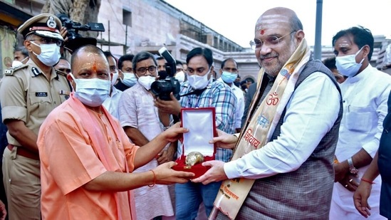 Uttar Pradesh Chief Minister Yogi Adityanath felicitates Union Home Minister Amit Shah at Kashi Vishwanath Temple, in Varanasi on August 1.(ANI)