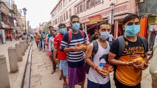 Few devotees follow protocols while others stand in line without masks as they visit Kashi Viswanath Temple on second 'Sawan' Monday.(PTI)