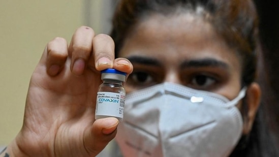 A health worker displays a vial of the Covaxin vaccine at a health centre in New Delhi.(AFP File Photo)