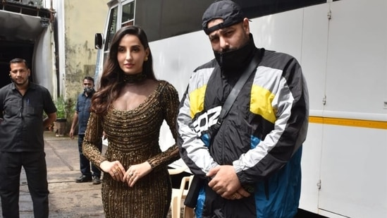 Nora Fatehi and Badshah posed for the paparazzi together outside a studio in Mumbai. While she wore a shimmery gown, he was more casually dressed.(Varinder Chawla)