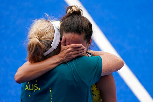 Australia's Brooke Peris is consoled by a member of the team staff after losing their women's field hockey match against India at the 2020 Summer Olympics, Monday, Aug. 2, 2021, in Tokyo, Japan. (AP Photo/John Locher) Australia's Brooke Peris is consoled by a member of the team staff after losing their women's field hockey match against India at the 2020 Summer Olympics, Monday, Aug. 2, 2021, in Tokyo, Japan. (AP Photo/John Locher)