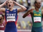 Karsten Warholm of Norway celebrates as he wins the gold medal in the final of the men's 400-meter hurdles at the 2020 Summer Olympics, in Tokyo on August 3. One of the most anticipated races on the program more than lived up to the hype as Warholm set a ridiculous world record to hold off American Rai Benjamin and take gold in the men's 400 metres hurdles, in what will go down as perhaps the greatest of Olympic races. (Martin Meissner / AP)