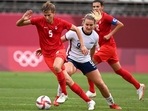 Canada's midfielder Quinn (L) is marked by USA's midfielder Lindsey Horan (R) during the Tokyo 2020 Olympic Games women's semi-final football match