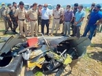 Police personnel inspect the site after a helicopter of the army crashed into the Ranjit Sagar Dam lake in Kathua on Tuesday. PTI(PTI) Police personnel inspect the site after a helicopter of the army crashed into the Ranjit Sagar Dam lake in Kathua on Tuesday. PTI(PTI)