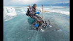 Photographer Dhritiman Mukherjee descends into an ice hole in the frozen-over Lake Baikal in Siberia. Mukherjee has been cold-water diving for five years and one of his main concerns returning to places where permanent ice structures dominate the landscape, is witnessing their depletion, he says. (Dhritiman Mukherjee) Photographer Dhritiman Mukherjee descends into an ice hole in the frozen-over Lake Baikal in Siberia. Mukherjee has been cold-water diving for five years and one of his main concerns returning to places where permanent ice structures dominate the landscape, is witnessing their depletion, he says. (Dhritiman Mukherjee)