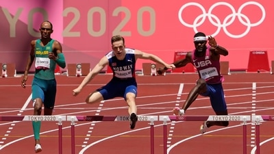 Karsten Warholm clears a hurdle before winning the gold medal at the Summer Olympics in Tokyo on August 3. "You know the cliché that it hasn't sunk in yet? I don't think it has, but I feel ecstatic," Warholm said after the race. "I can't believe the time, it's so fast. A lot of the time I am asked about the perfect race. I said it didn't exist but this is the closest I've ever come,” Reuters reported. (Charlie Riedel / AP) Karsten Warholm clears a hurdle before winning the gold medal at the Summer Olympics in Tokyo on August 3. "You know the cliché that it hasn't sunk in yet? I don't think it has, but I feel ecstatic," Warholm said after the race. "I can't believe the time, it's so fast. A lot of the time I am asked about the perfect race. I said it didn't exist but this is the closest I've ever come,” Reuters reported. (Charlie Riedel / AP)