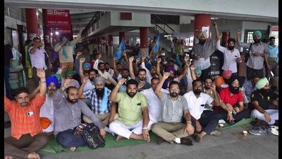 Members of the Punbus Contractual Employees’ Union protesting at the Ludhiana bus stand on Tuesday. (Gurpreet SIngh/HT)