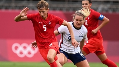 Canada's midfielder Quinn (L) is marked by USA's midfielder Lindsey Horan (R) during the Tokyo 2020 Olympic Games women's semi-final football match (AFP) Canada's midfielder Quinn (L) is marked by USA's midfielder Lindsey Horan (R) during the Tokyo 2020 Olympic Games women's semi-final football match (AFP)