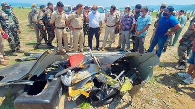 Police personnel inspect the site after a helicopter of the army crashed into the Ranjit Sagar Dam lake in Kathua on Tuesday. PTI (PTI) Police personnel inspect the site after a helicopter of the army crashed into the Ranjit Sagar Dam lake in Kathua on Tuesday. PTI (PTI)
