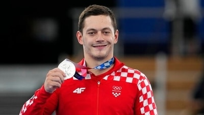 Tin Srbic, of Croatia, hold his silver medal after competition on the horizontal bar during the artistic gymnastics men's apparatus final at the 2020 Summer Olympics, Tuesday, Aug. 3, 2021, in Tokyo, Japan. (AP Photo/Natacha Pisarenko) (AP) Tin Srbic, of Croatia, hold his silver medal after competition on the horizontal bar during the artistic gymnastics men's apparatus final at the 2020 Summer Olympics, Tuesday, Aug. 3, 2021, in Tokyo, Japan. (AP Photo/Natacha Pisarenko) (AP)