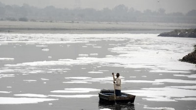 A man rows a boat in the heavily polluted waters of the Yamuna River. (Biplov Bhuyan/HT PHOTO)