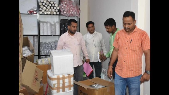 A Ludhiana municipal corporation team during a raid at a shop in Jawahar Nagar Camp on Tuesday. (Harsimar Pal Singh/HT)