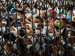 People wearing masks stand in line wait to receiving a dose of the vaccine against Covid, during a vaccination program at the provincial govt building in Medan, North Sumatra province, Indonesia.