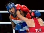 Lovlina Borgohain, of India, left, and Busenaz Surmeneli, of Turkey, exchange punches during their women's welter weight 64-69kg semifinal boxing match at the 2020 Summer Olympics, Wednesday, Aug. 4, 2021, in Tokyo, Japan.