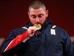Lasha Talakhadze of Georgia poses with the gold medal. 