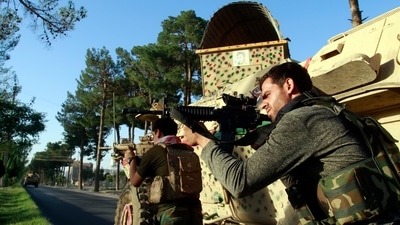 Afghan security personnel take a position during fighting between Taliban and Afghan security forces, in Herat province on Tuesday. (AP Photo) Afghan security personnel take a position during fighting between Taliban and Afghan security forces, in Herat province on Tuesday. (AP Photo)