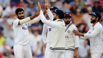 Jasprit Bumrah celebrates taking the wicket of England's Jos Buttler with teammates (Action Images via Reuters)