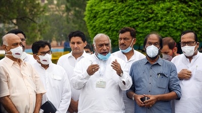 Senior Congress leader Mallikarjun Kharge along with other opposition party leaders and MPs addresses the media outside Parliament House. Kharge is among the leaders who signed the joint statement. (ANI Photo)