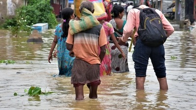 People walk through the floodwater with their belongings after heavy rainfall hit Udayanarayanpur, Howrah, in Kolkata on July 3. (ANI) People walk through the floodwater with their belongings after heavy rainfall hit Udayanarayanpur, Howrah, in Kolkata on July 3. (ANI)