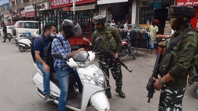 Security personnel check the ID of a vehicle ahead of the second anniversary of abrogation Article 370, in Srinagar on Wednesday. (ANI Photo)