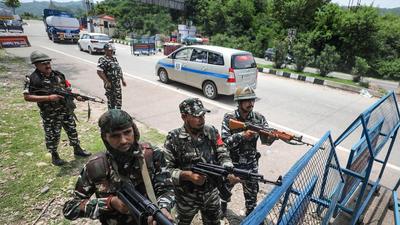 CRPF soldiers stand guard at J&K National Highway on the eve of the 2nd anniversary of abrogation of Article 370 and bifurcation of J&K into two union territories, in Jammu, Wednesday. (PTI) CRPF soldiers stand guard at J&K National Highway on the eve of the 2nd anniversary of abrogation of Article 370 and bifurcation of J&K into two union territories, in Jammu, Wednesday. (PTI)