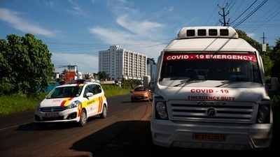 A vehicle used for Covid-19 emergency is parked on a roadside as other vehicles drive past during a weekend lockdown to curb the spread of coronavirus in Kochi, Kerala. (RS Iyer / AP) A vehicle used for Covid-19 emergency is parked on a roadside as other vehicles drive past during a weekend lockdown to curb the spread of coronavirus in Kochi, Kerala. (RS Iyer / AP)