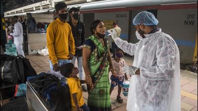 A healthcare worker collects swab samples for Covid-19 test of the passengers arriving from outstation trains at Dadar station. (Pratik Chorge/HT PHOTO) A healthcare worker collects swab samples for Covid-19 test of the passengers arriving from outstation trains at Dadar station. (Pratik Chorge/HT PHOTO)