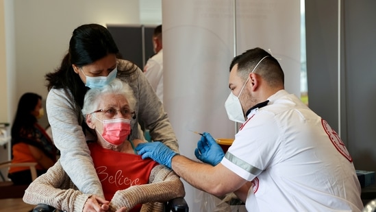 An elderly woman receives a booster shot of her vaccination against the Covid-19 at an assisted living facility, in Netanya, Israel(Reuters)