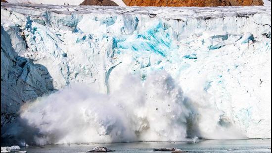 A mass of ice breaking away from the Apusiajik glacier, near Kulusuk (aslo spelled Qulusuk), a settlement in Sermersooq on the southeastern shore of Greenland. The Arctic has warmed three times more quickly than the planet as a whole, and faster than previously thought. (AFP)