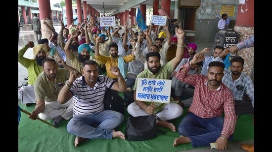 Members of the Punbus Contractual Employees’ Union protesting at the Ludhiana bus stand on Wednesday. (Gurpreet Singh/HT)