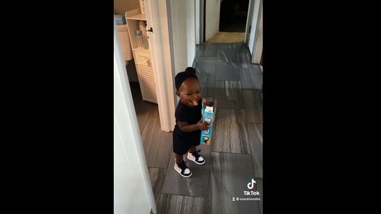 The image shows the little girl whose dad caught her stealing snacks.(Instagram/@snackbandits_dad)