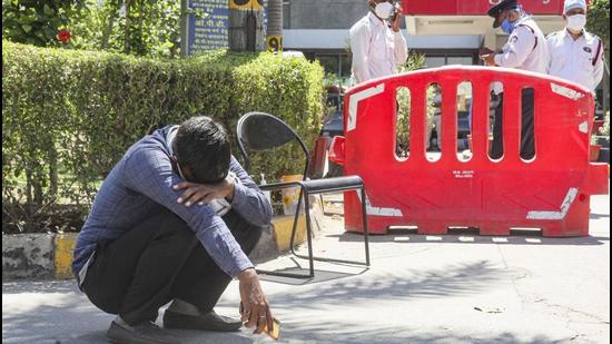 A man breaks down after losing a relative at Jaipur Golden hospital, Rohini, in April 2021. At least 20 critical Covid-19 patients died amid oxygen scarcity in this hospital. (PTI Photo)