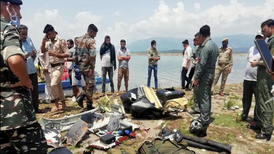 Army personnel inspect the site after a helicopter of the Indian Army crashed near Ranjit Sagar Dam Lake in Kathua district. (PTI)