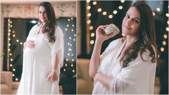 Neha looked like a goddess in this white Kaftan by ace designer Manish Malhotra. She kept her look simple by just accessorising it with a shimmery hand purse.(Instagram/@nehadhupia)