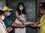 Kajol cutting her birthday cake with her fans.