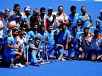 Members of the India team pose for photographs after defeating Germany 5-4 during the men's field hockey bronze medal match.