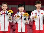 Gold medalists Chen Meng, Sun Yingsha and Wang Manyu of Team China celebrate on the podium. (Getty Images)