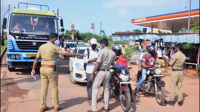 Police personnel check Covid-19 test reports of travellers at Talapady checkpost at the Kerala-Karnataka border in Mangaluru. (PTI PHOTO.) Police personnel check Covid-19 test reports of travellers at Talapady checkpost at the Kerala-Karnataka border in Mangaluru. (PTI PHOTO.)